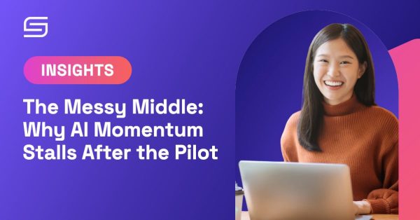 Smoothstack Insights graphic: a smiling professional working on a laptop, for an article on why AI pilots stall after launch